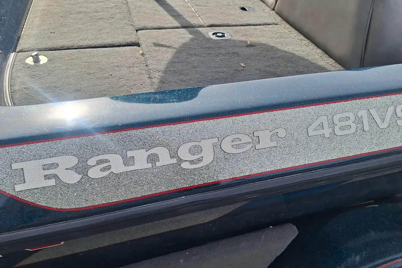 Slide: The Image of 1994 Ranger 481VS boat with textured logo and carpeted interior. - 7
