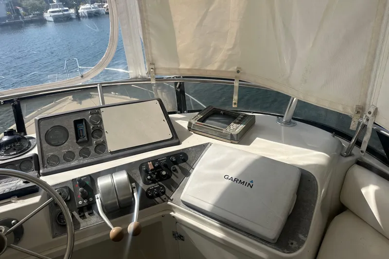 Slide: The Image of 1991 Carver Californian 48 yacht helm with Garmin navigation system, overlooking marina. - 20