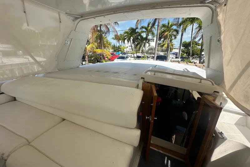 Slide: The Image of 1991 Carver Californian 48 yacht interior with open hatch, palm trees visible outside. - 23