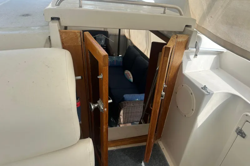 Slide: The Image of Interior view of 1991 Carver Californian 48 yacht with open wooden doors. - 24