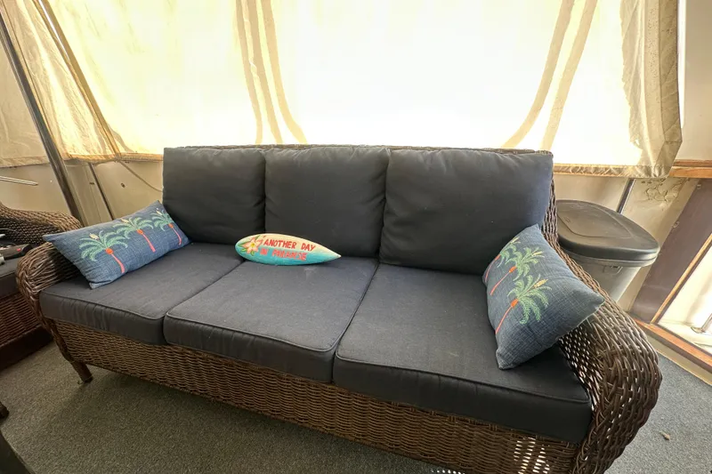 Slide: The Image of Wicker sofa with blue cushions and tropical pillows on Carver Californian 48 yacht, 1991. - 28