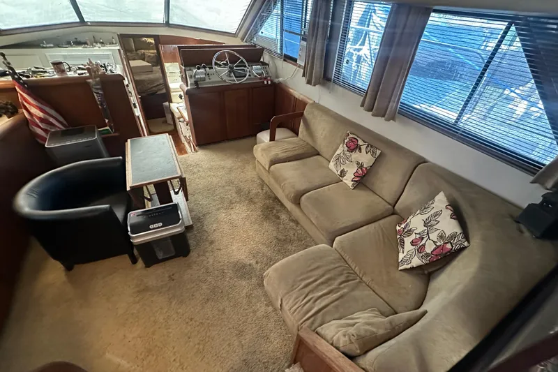 Slide: The Image of Interior of 1991 Carver Californian 48 yacht with cozy seating and helm station. - 32