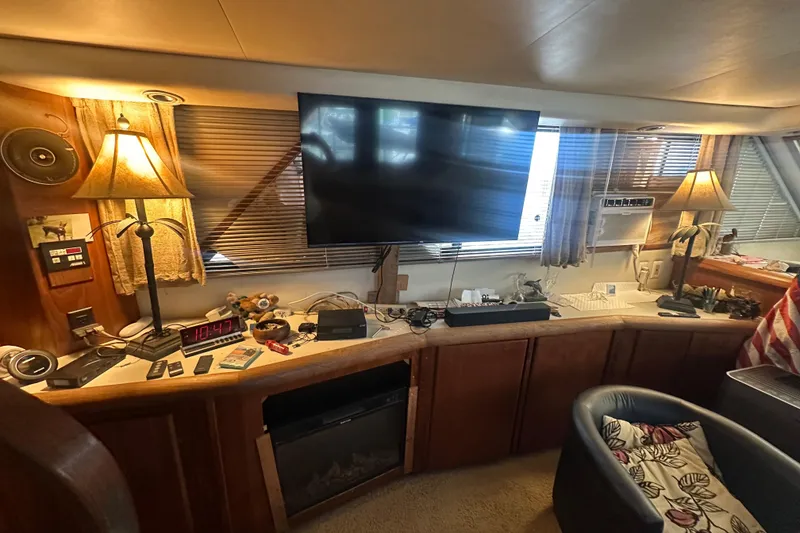 Slide: The Image of Interior of 1991 Carver Californian 48 yacht with TV, lamps, and cozy seating area. - 34
