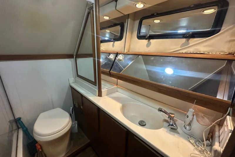 Slide: The Image of Bathroom interior of 1991 Carver Californian 48 yacht with sink, mirror, and toilet. - 59