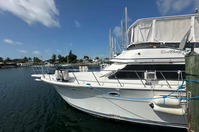 Slide: The Image of 1991 Carver Californian 48 yacht docked in a sunny marina setting. - 6