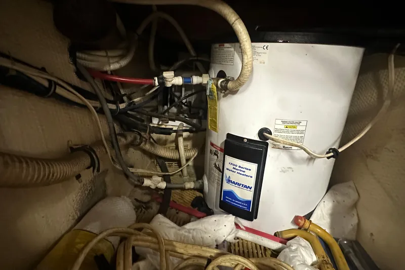 Slide: The Image of Engine room of 1991 Carver Californian 48 with marine water heater and wiring. - 64