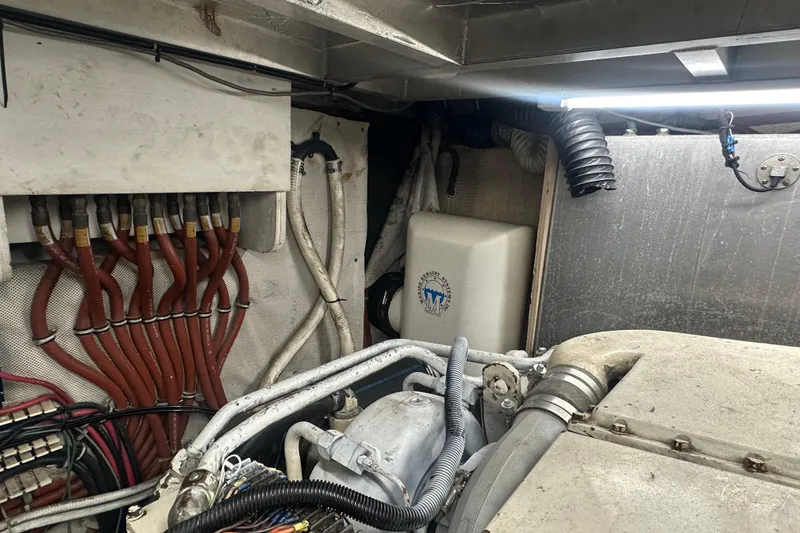Slide: The Image of Engine room of 1991 Carver Californian 48 yacht with visible wiring and components. - 65