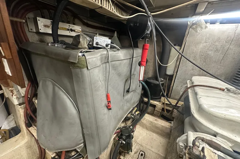 Slide: The Image of Engine room of a 1991 Carver Californian 48 yacht, showcasing mechanical components. - 66