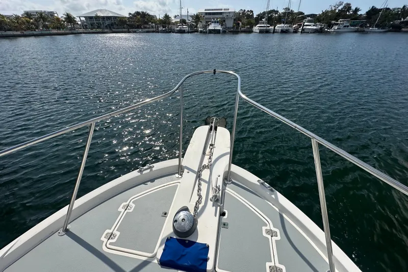 Slide: The Image of Bow view of 1991 Carver Californian 48 yacht in a marina setting. - 10