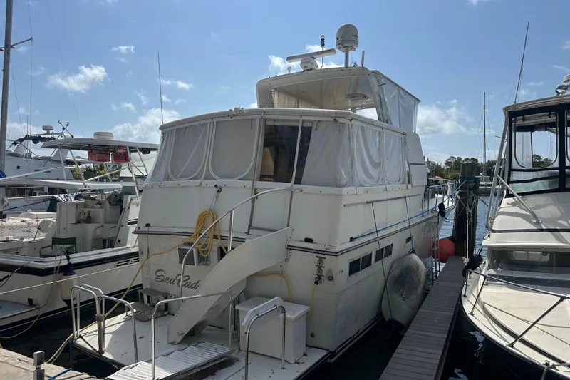 Slide: The Image of 1991 Carver Californian 48 yacht docked at marina under clear blue sky. - 13