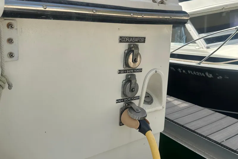 Slide: The Image of 1991 Carver Californian 48 boat with shore power connections at dock. - 15