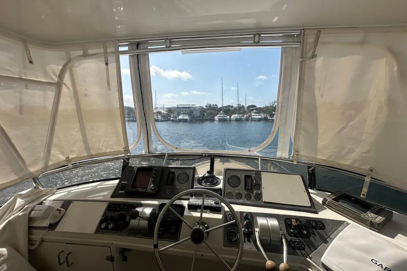 Slide: The Image of Interior view of 1991 Carver Californian 48 yacht cockpit with marina in background. - 17