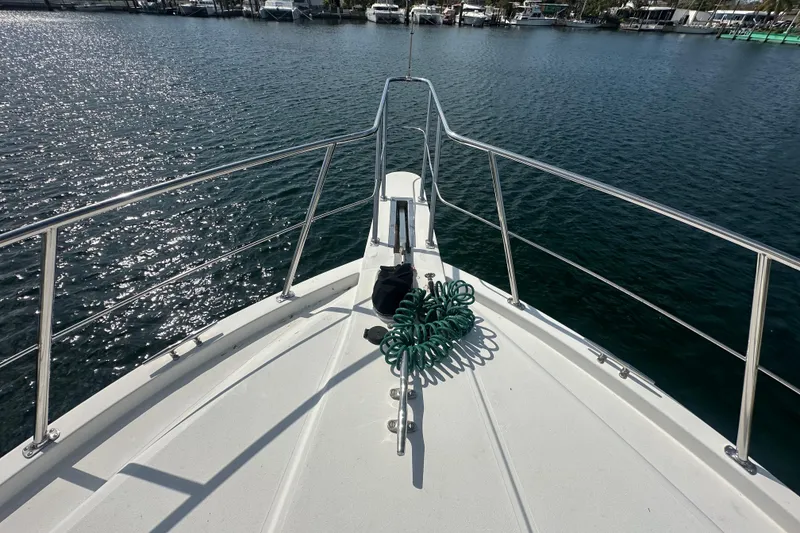 Slide: The Image of Bow view of 1991 Carver Californian 48 yacht on calm water. - 2