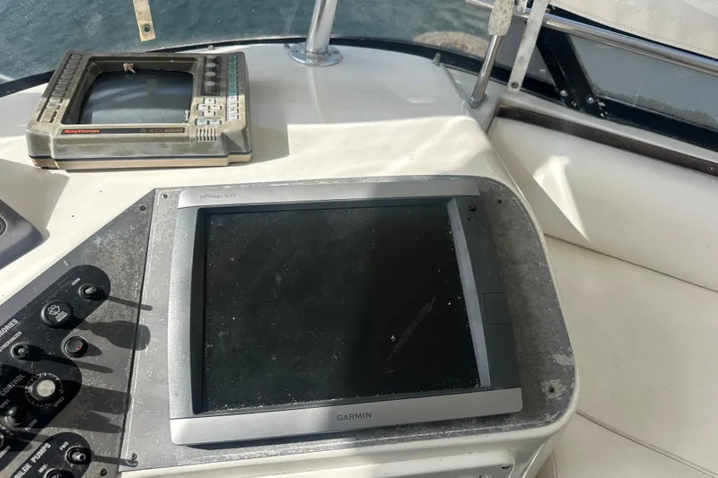 Slide: The Image of Control panel of 1991 Carver Californian 48 yacht with Garmin and Raytheon equipment. - 21