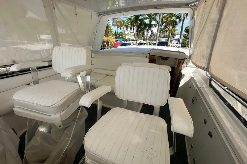 Slide: The Image of Interior of 1991 Carver Californian 48 yacht with white seating and palm trees outside. - 22
