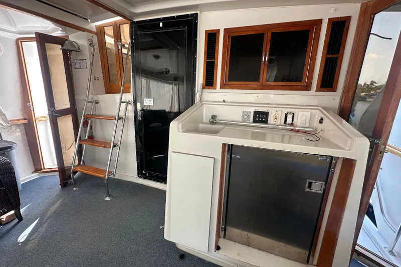 Slide: The Image of Interior of 1991 Carver Californian 48 yacht with kitchenette and wooden accents. - 26