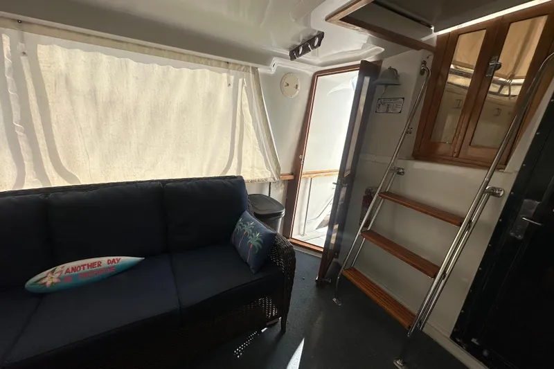 Slide: The Image of Interior of 1991 Carver Californian 48 yacht with sofa, stairs, and wooden accents. - 27