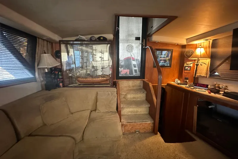 Slide: The Image of Interior of 1991 Carver Californian 48 yacht with cozy seating and nautical decor. - 29