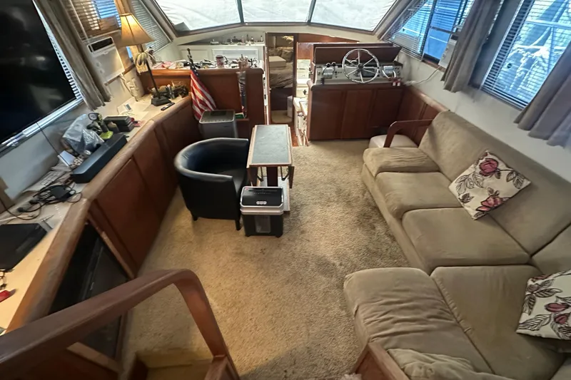 Slide: The Image of Interior of a 1991 Carver Californian 48 yacht with cozy seating and helm. - 33