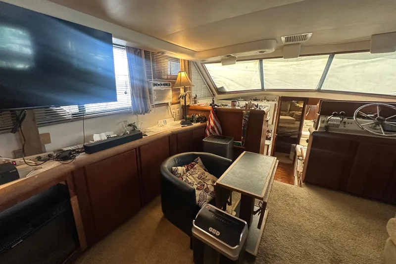 Slide: The Image of Interior of 1991 Carver Californian 48 yacht with cozy seating and helm area. - 35
