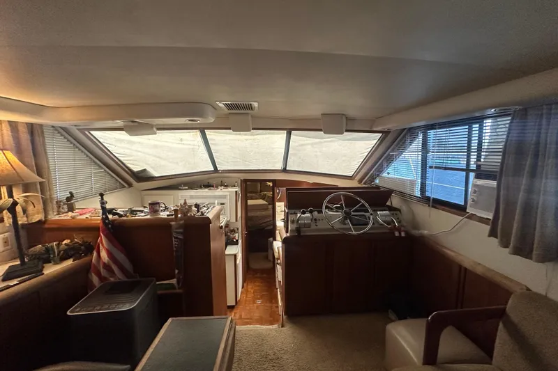 Slide: The Image of Interior of 1991 Carver Californian 48 yacht with helm, windows, and cozy seating area. - 37