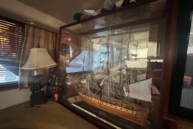 Slide: The Image of Model ship display inside a 1991 Carver Californian 48 yacht, with a lamp and blinds nearby. - 38