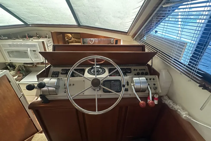 Slide: The Image of 1991 Carver Californian 48 yacht helm with steering wheel and control panel. - 41