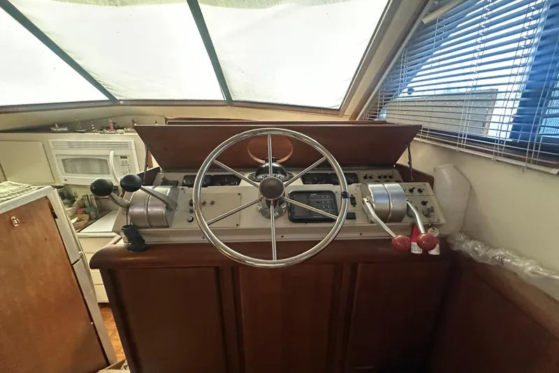 Slide: The Image of Interior helm of 1991 Carver Californian 48 yacht with steering wheel and controls. - 42