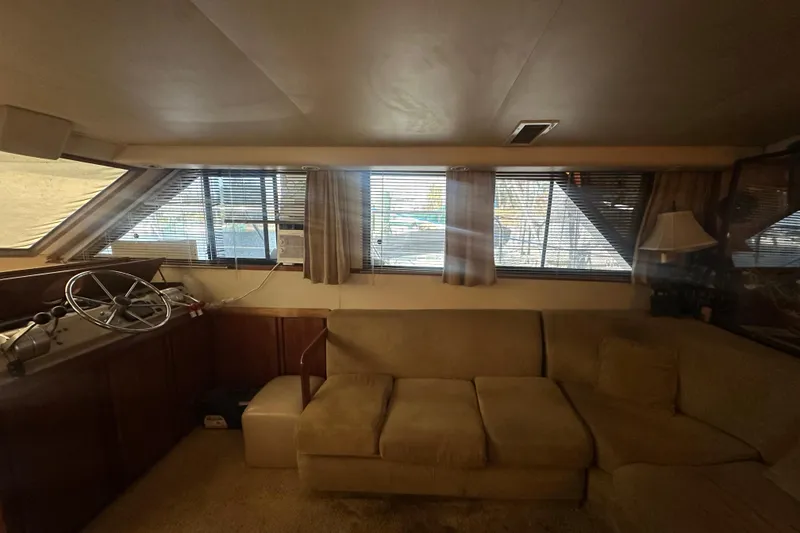 Slide: The Image of Interior of 1991 Carver Californian 48 yacht with beige sofa and helm station. - 43