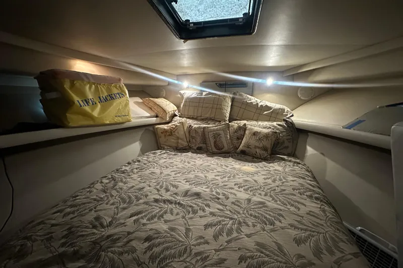 Slide: The Image of Cozy cabin interior of 1991 Carver Californian 48 yacht with tropical bedding and life jackets. - 56