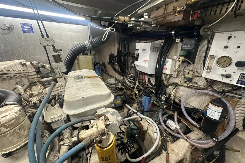 Slide: The Image of Engine room of a 1991 Carver Californian 48 yacht, showcasing mechanical components and wiring. - 63
