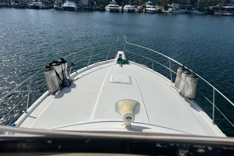 Slide: The Image of Bow view of 1991 Carver Californian 48 yacht docked in a marina. - 8