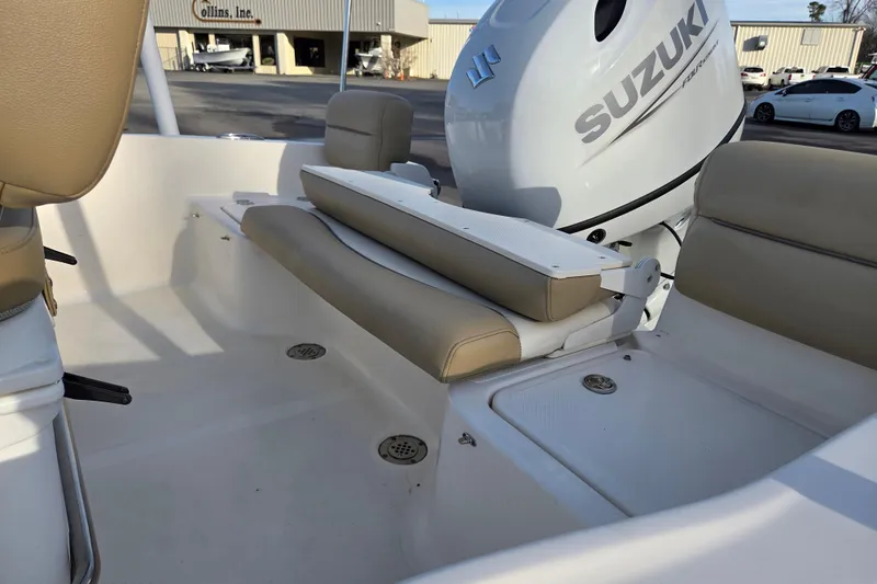 Slide: The Image of 2020 Pioneer 180 Islander boat interior with Suzuki outboard motor, beige seating. - 11
