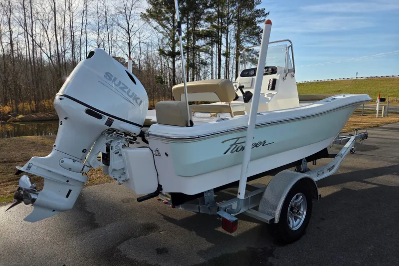 Slide: The Image of 2020 Pioneer 180 Islander boat with Suzuki outboard motor on a trailer. - 2