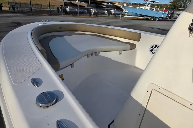 Slide: The Image of 2020 Pioneer 180 Islander boat interior with cushioned seating and speaker. - 8