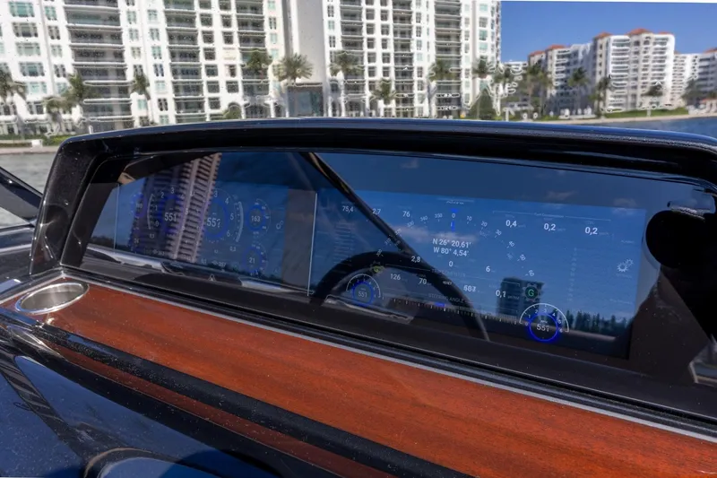 Slide: The Image of Dashboard of 2025 Riva 33' Aquariva Special with digital display and cityscape reflection. - 13