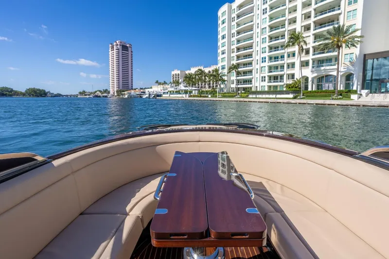 Slide: The Image of Luxurious 2025 Riva 33' Aquariva Special yacht cruising near waterfront buildings. - 18