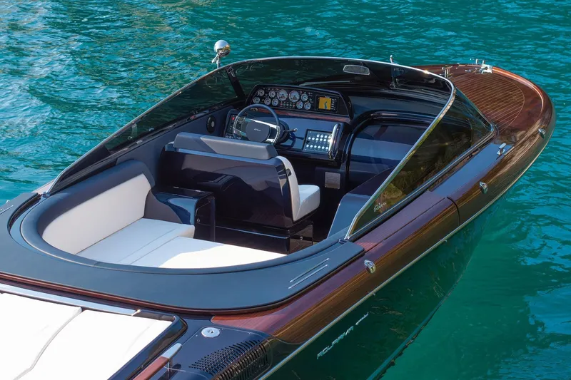 Slide: The Image of 2025 Riva 33' Aquariva Special cruising on a scenic waterway with palm trees. - 2