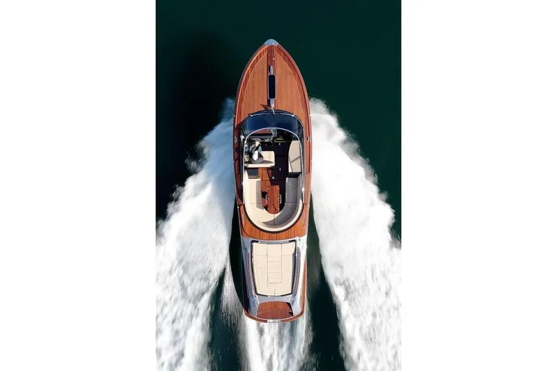Slide: The Image of Overhead view of a 2025 Riva yacht cruising on water, leaving a wake. - 9