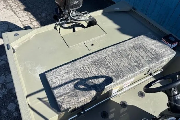 Slide: The Image of 2026 Tracker Grizzly 1860 CC boat interior with camouflage seating and steering console. - 10