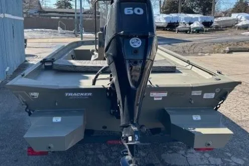 Slide: The Image of 2026 Tracker Grizzly 1860 CC boat with 60 HP outboard motor, parked outdoors. - 4