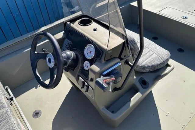 Slide: The Image of 2026 Tracker Grizzly 1860 CC boat console with steering wheel and gauges. - 9