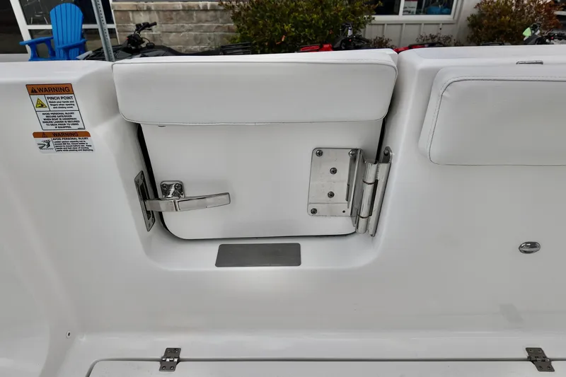 Slide: The Image of 2026 Sea Fox 268 Commander boat interior with white cushioned seating and safety warnings. - 11