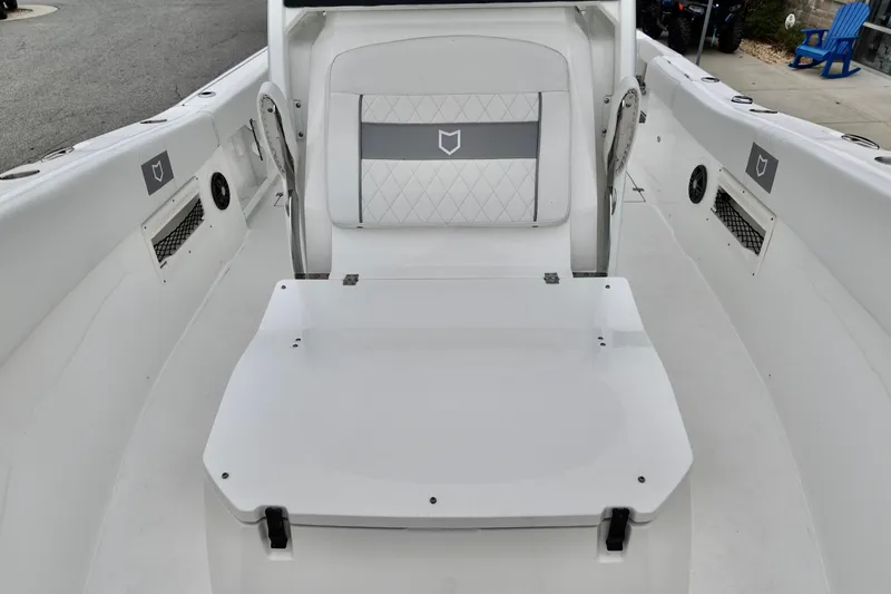 Slide: The Image of 2026 Sea Fox 268 Commander boat interior with white seating and storage. - 16