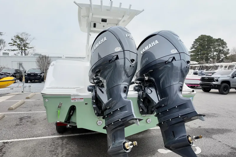 Slide: The Image of 2026 Sea Fox 268 Commander with dual Yamaha outboard engines in a parking lot. - 2