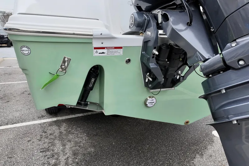 Slide: The Image of 2026 Sea Fox 268 Commander boat stern with outboard motor in parking lot. - 23