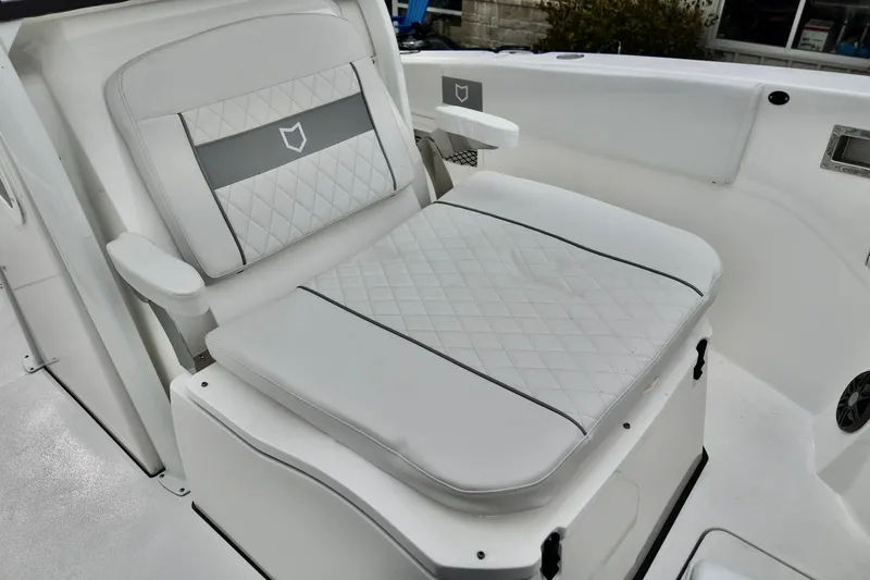 Slide: The Image of 2026 Sea Fox 268 Commander boat seat with white quilted upholstery and armrests. - 5