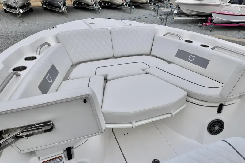 Slide: The Image of 2026 Sea Fox 268 Commander boat interior with white cushioned seating and cup holders. - 7