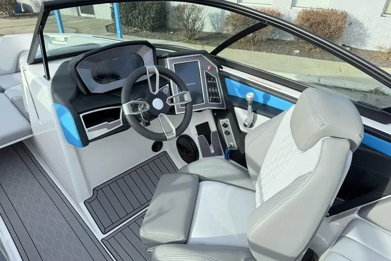 Slide: The Image of 2023 MasterCraft XT22 boat interior with modern dashboard and steering wheel. - 12