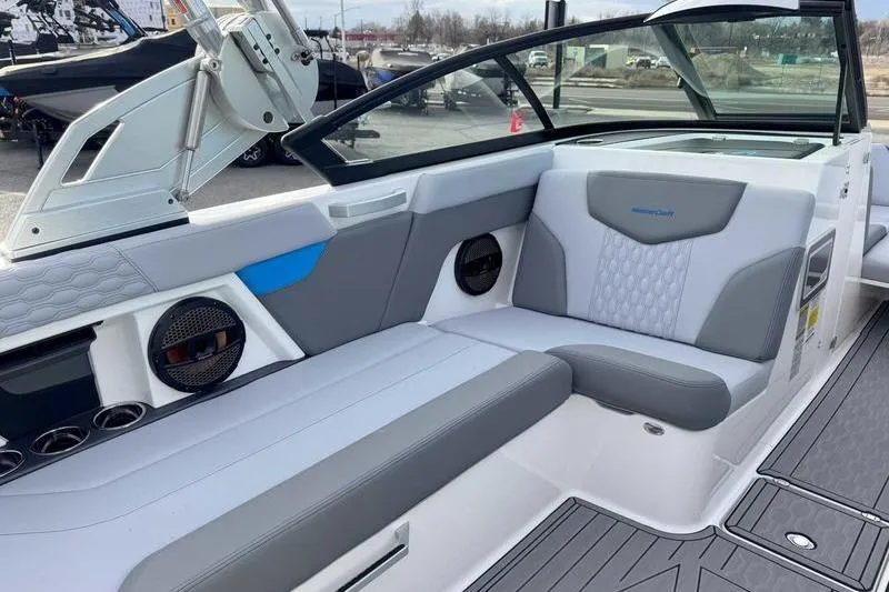 Slide: The Image of 2023 MasterCraft XT22 boat interior with gray and white seating, modern design. - 7